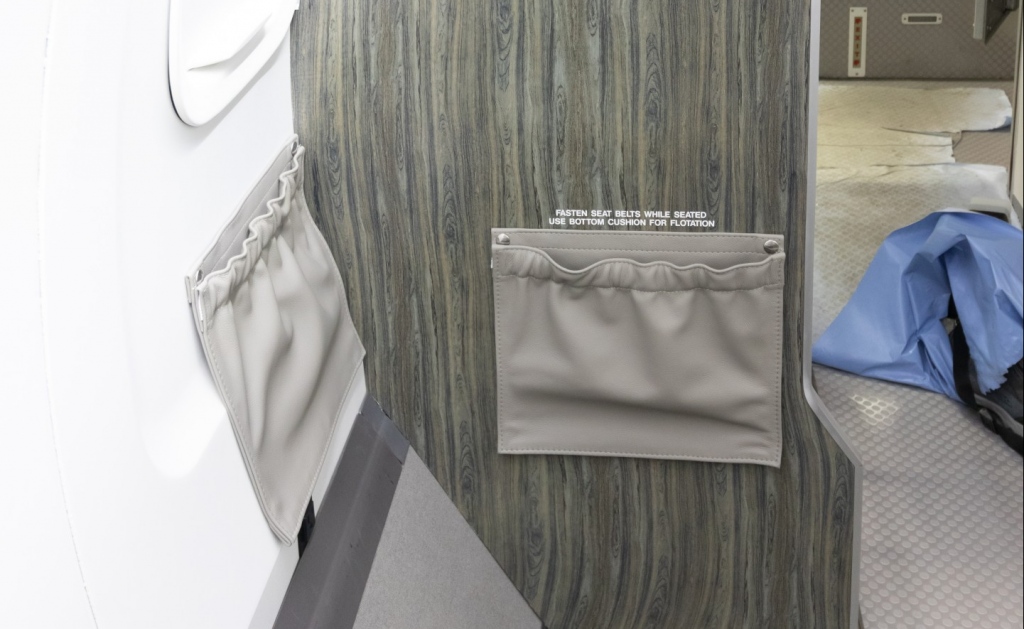 Interior regional aircraft conversion on Embraer aircraft - photo of aircraft cabinetry with two pockets