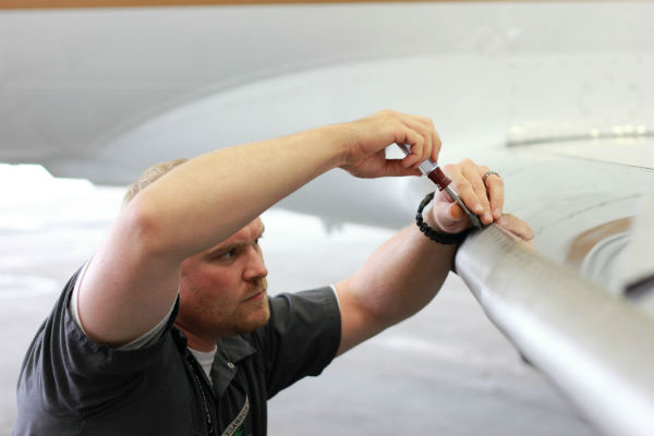 Aircraft Technician Installing TKS panels