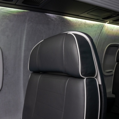 Interior regional aircraft conversion on Embraer aircraft - photo of aircraft seat and closed window shade
