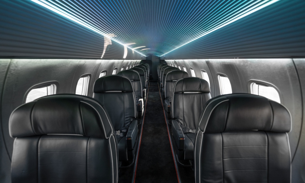Interior regional aircraft conversion on Embraer aircraft - photo of brightly lit aircraft aisle with one seat on either side
