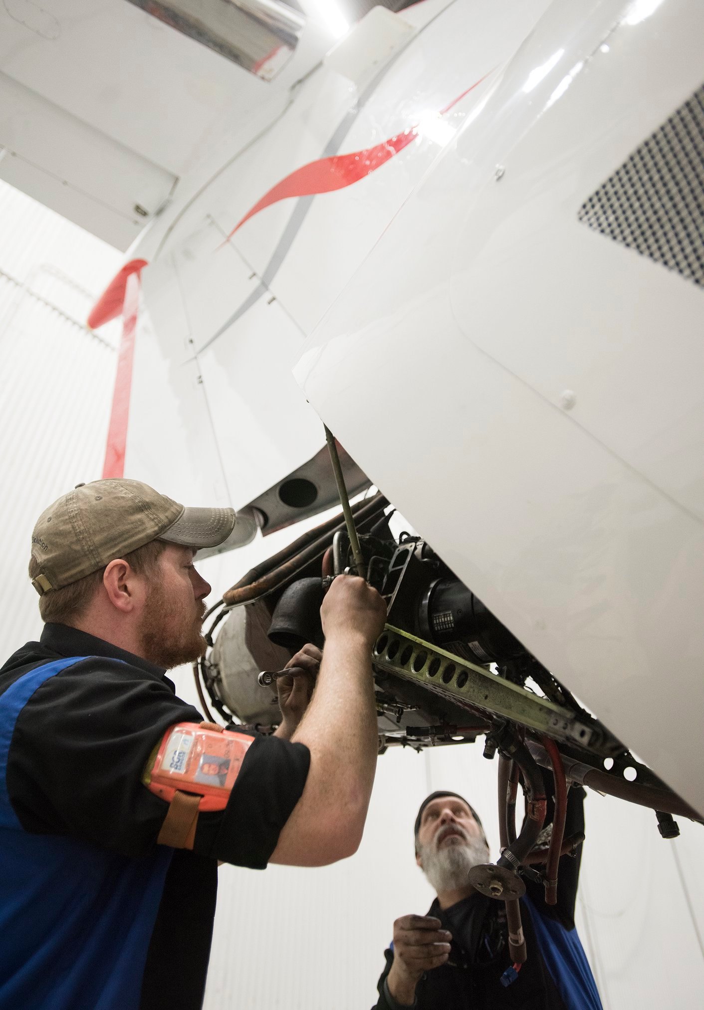 Interior Regional Aircraft Conversion On Embraer Aircraft - Photo Of A  Worker Using Equipment To Pull An Aircraft Into A Hanger - C&L Aero