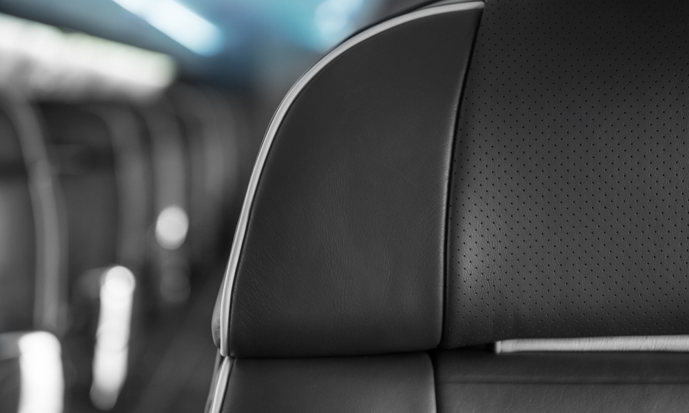 Interior regional aircraft conversion on Embraer aircraft - upclose photo of black aircraft seat upholstry