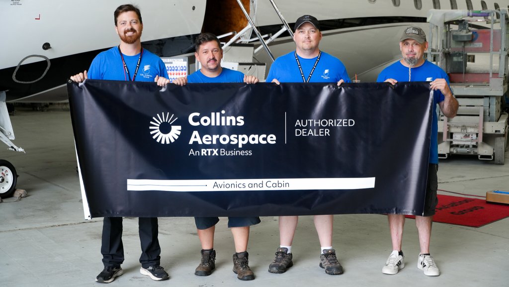 C&L Aviation Group avionics technicians hold a banner recognizing C&L as an authorized dealer for Collins Aerospace 